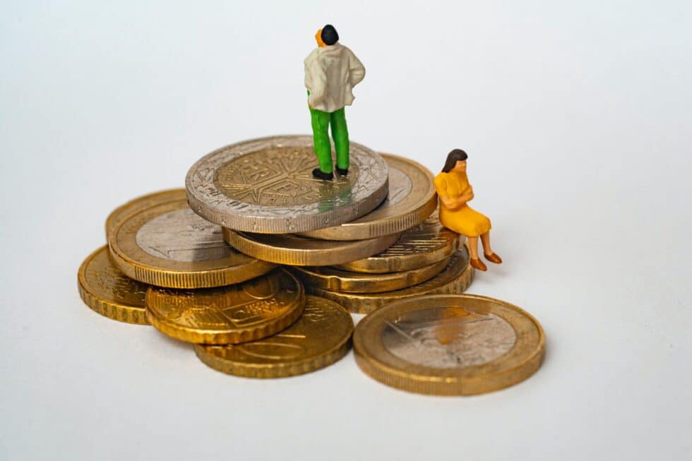The picture shows two figures sitting on coins. Income is very important at Naturalization .