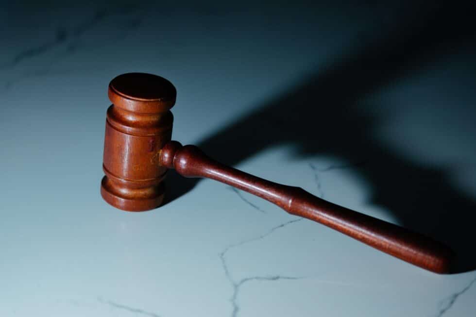 This picture shows a judge's gavel on a white background.