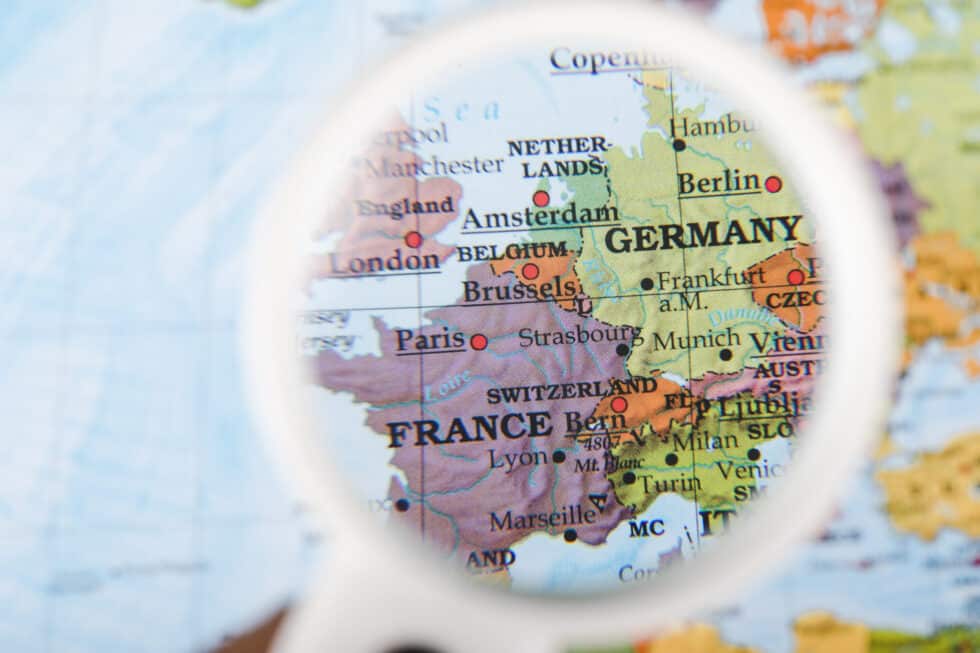 In this photo you can see a map of Germany and France through a magnifying glass