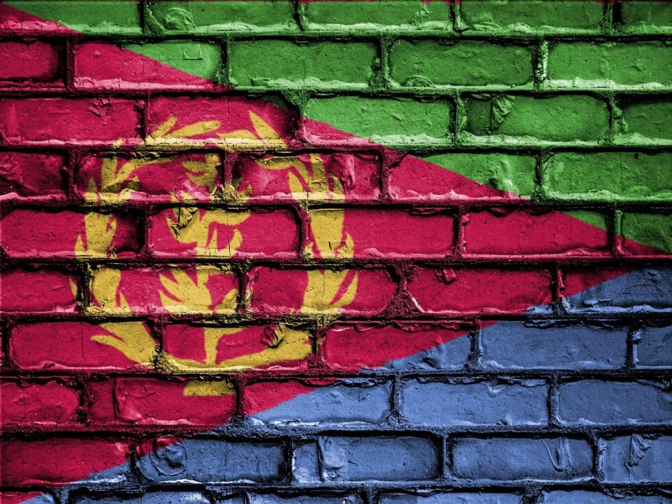 The Eritrean flag flies proudly on a wall, its green, red and blue colors symbolizing unity, bloodshed for freedom and the independent spirit of the country.