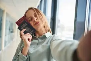 A woman holds two passports in her hand. An example of dual citizenship in Germany.