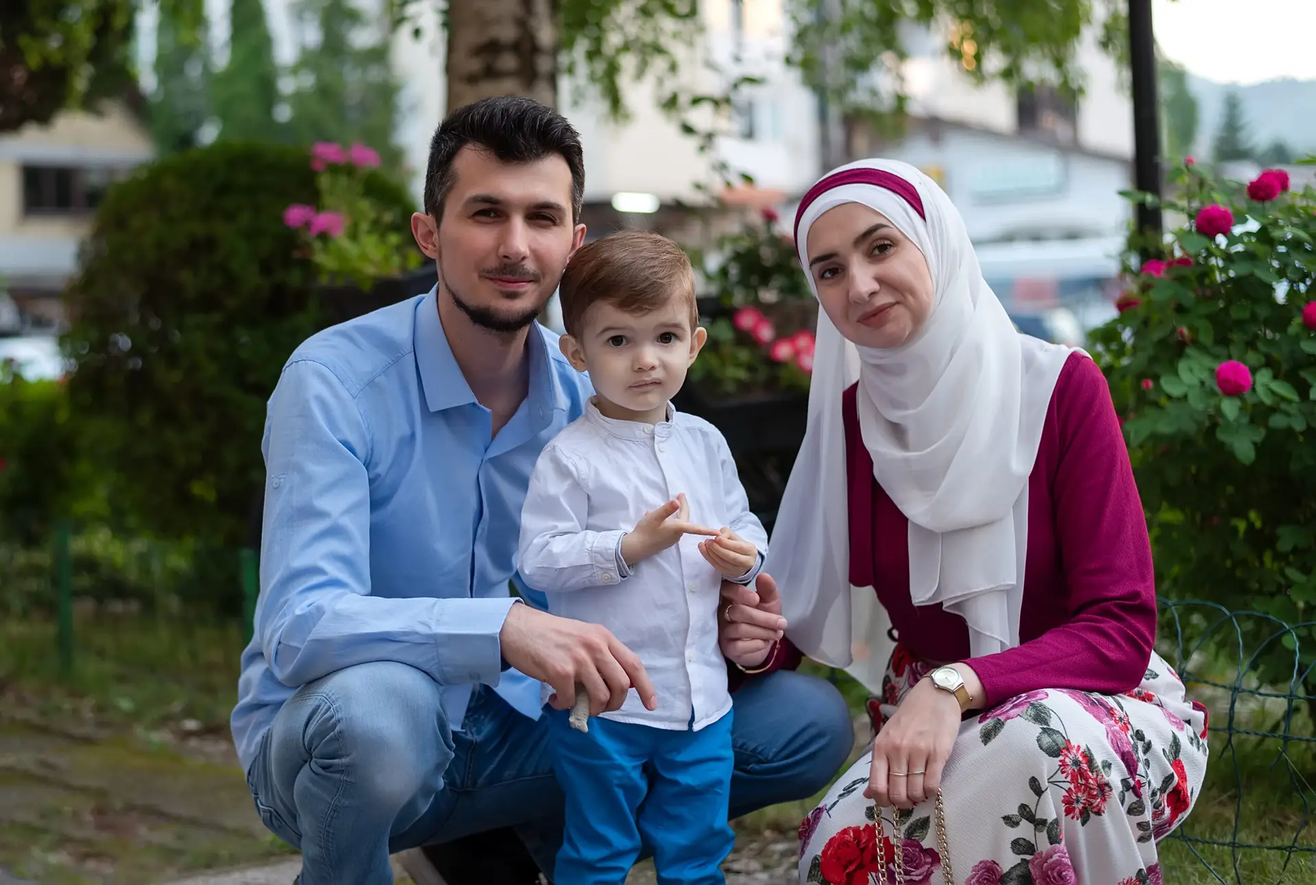 Familie mit Mutter, Vater und Kind in einem Sommergarten im Kontext von § 33 AufenthG