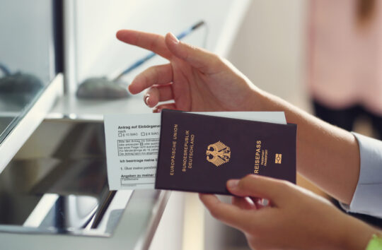 Auf diesem Bild sehen Sie eine Person mit einem deutschen Pass am Schalter. Symbol für das Thema erleichterte Einbürgerung