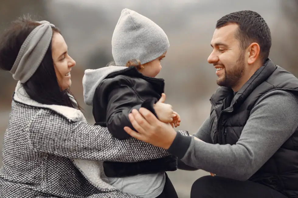 The picture shows a young family with a migration background: two parents and a young daughter. The German government decides to stop family reunification for those in need of subsidiary protection. But what are the consequences for asylum seekers?